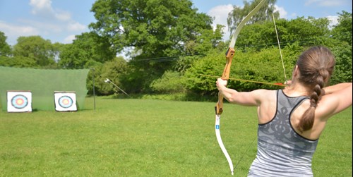 Young person taking part in archery. 