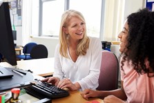 Young person talking to a careers advisor on a one-to-one with computer