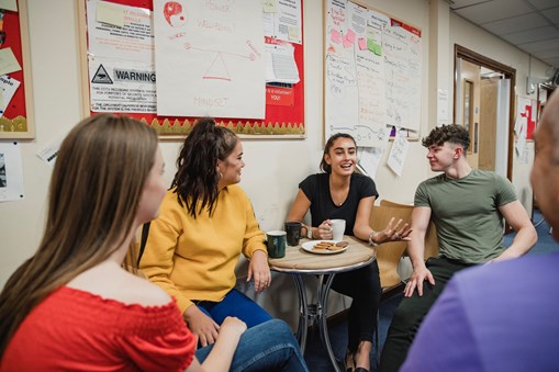 Group of young people sitting and talking.