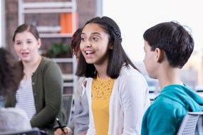 A group of young people sat down and talking.