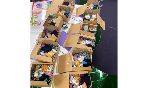 Care packages made by young people - cardboard boxes full of biscuits, food items, poems for older people.