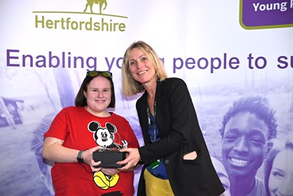 Jo Fisher with a young person collecting her award