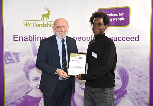 Councillor Makr Mills-Bishop with young person collecting their award