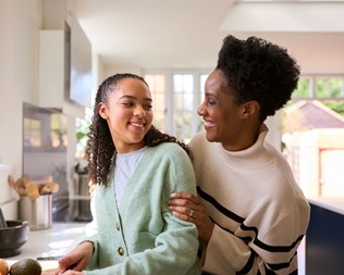 Mother and daughter smiling at each other.