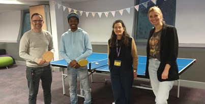 Practical Partners staff standing in front of a table tennis