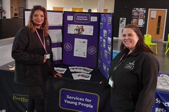 Youth workers standing in front of the SfYP stand