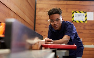 Young black man working as a carpenter