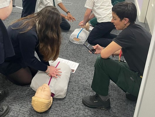 Young person being taught CPR.